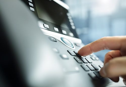 Dialing a telephone in the office Dialing telephone keypad concept for communication, contact us and customer service support
